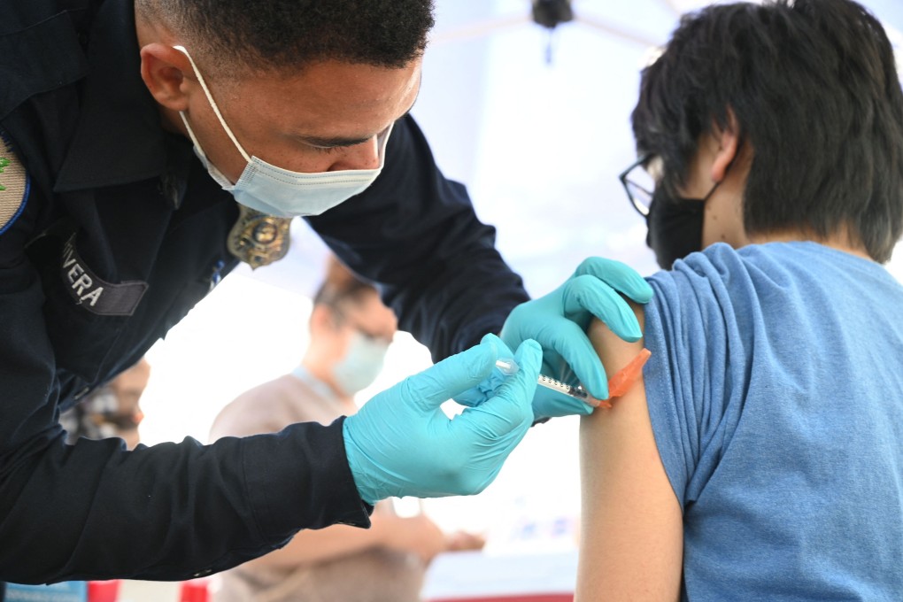 A heath worker give a young patient a jab at a pop-up Covid-19 vaccine clinic Los Angeles in August. Photo: AFP