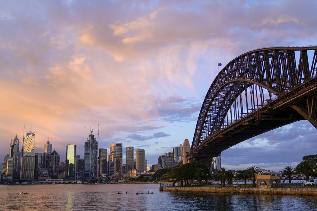 The sun rises over the skyline of Sydney’s central business district. Photo: AP