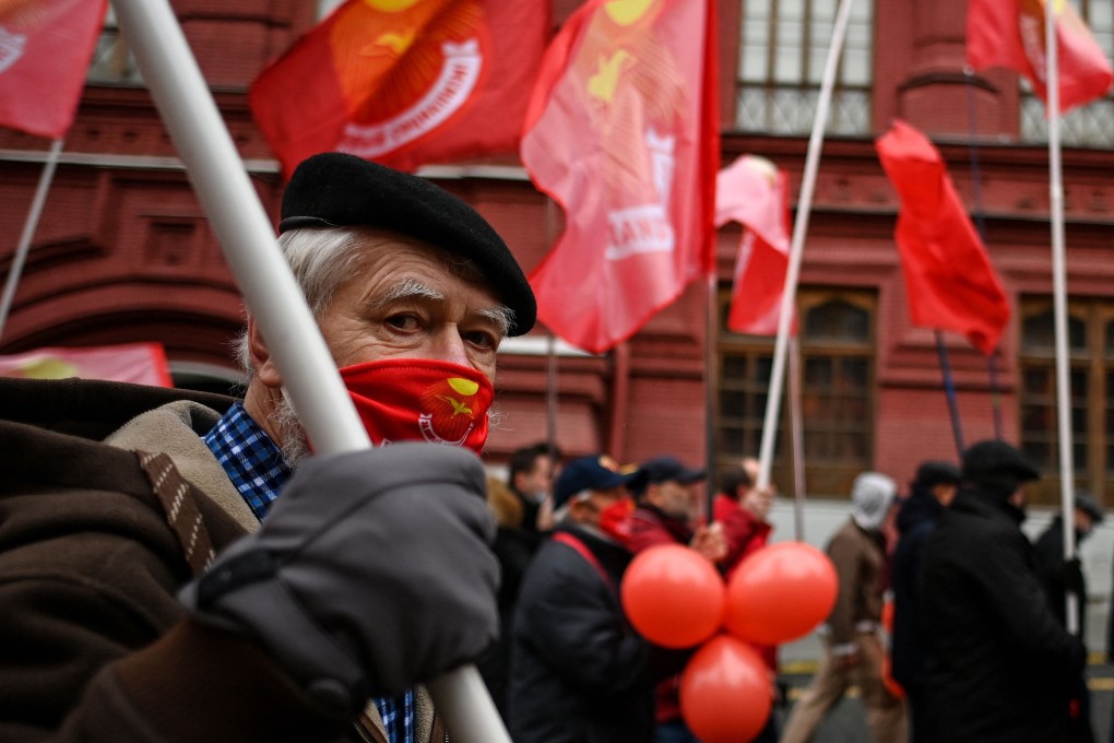 A Russian Communist Party supporter wearing a protective mask attends an annual wreath-laying ceremony in a deserted Red Square amid the Covid-19 pandemic in Moscow on Friday. Photo: AFP