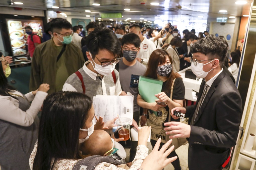 Property buyers queue for the Manor Hill flats at Lohas Park in Tseung Kwan O, at the sales office of Kowloon Development at Pioneer Centre in Mong Kok on 30 October 2021. Photo: Jonathan Wong.