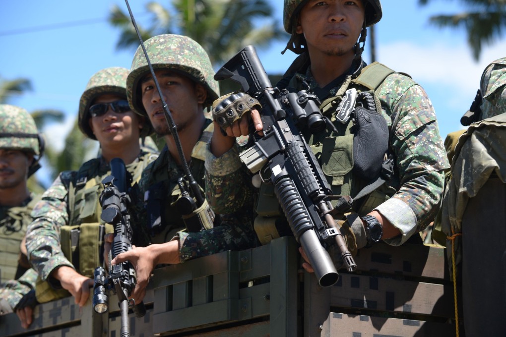 Philippine troops ride on their truck on the southern island of Mindanao, where a weekend operation saw the killing of a top rebel commander. Photo: AFP