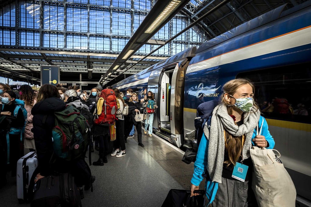Rail passengers leave a special Climate Summit train to transfer to a second train that will take them to Glasgow on October 30, 2021. Photo: EPA-EFE