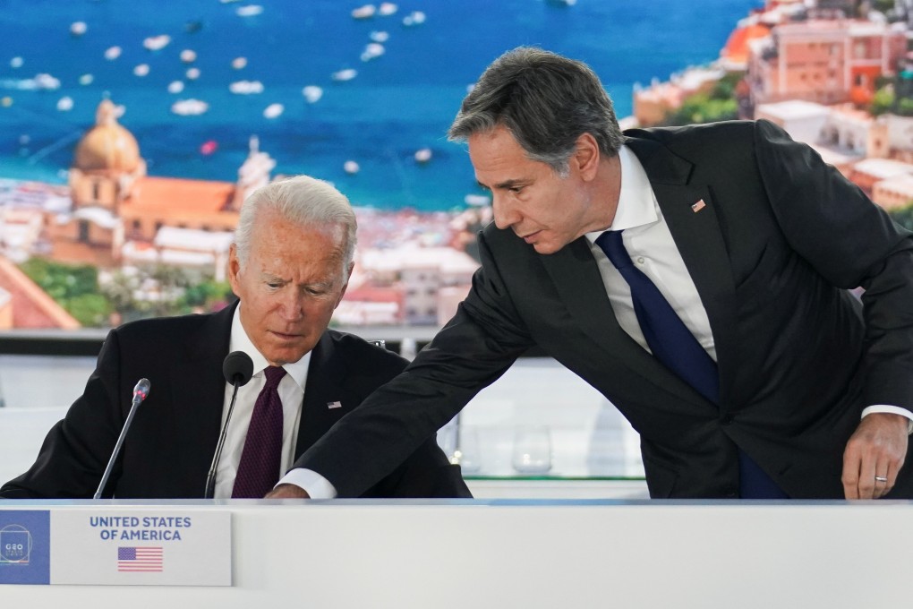 US Secretary of State Antony Blinken adjusts a microphone for President Joe Biden during an event at the G20 meetings in Rome on Sunday. Photo: Reuters