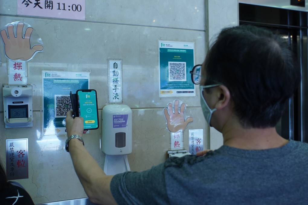 A man uses the “Leave Home Safe” at a restaurant in Mong Kok. Photo: Sam Tsang