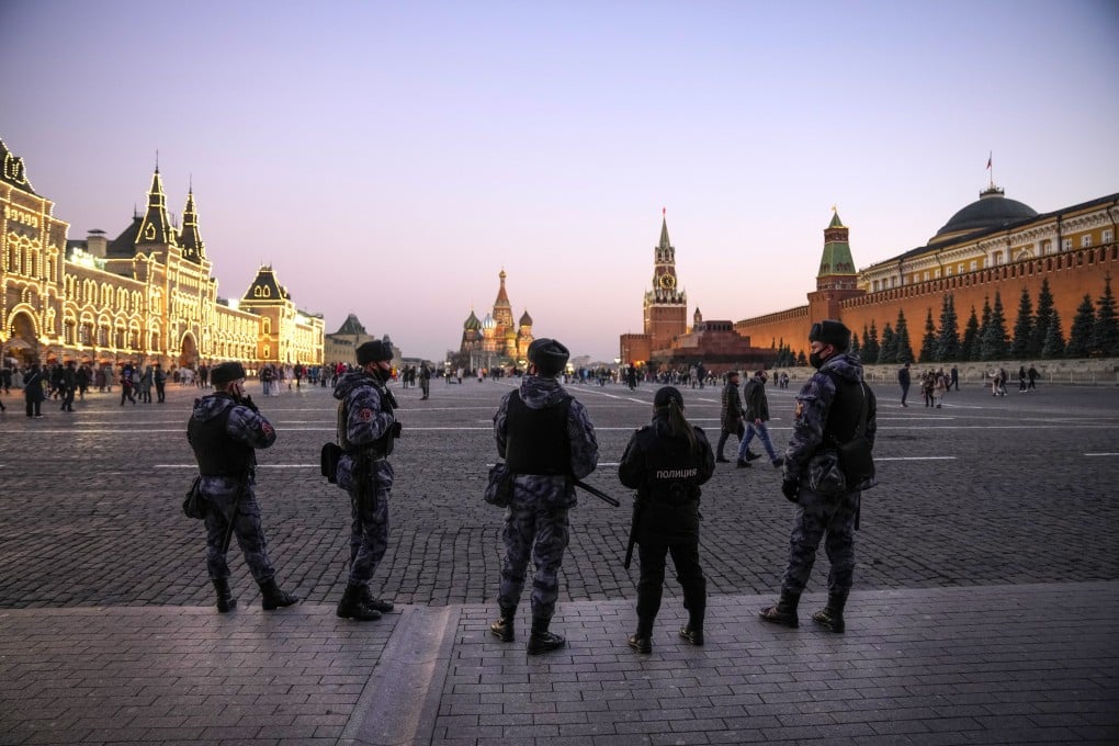 Russian National Guard soldiers stand in Red Square during a patrol of the area at sunset on Monday. Photo: AP