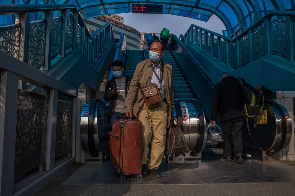 Passengers at the Beijing Railway Station on Friday. Authorities have urged residents not to leave the capital unless necessary and restricted people from entering the city from infected areas. Photo: EPA-EFE