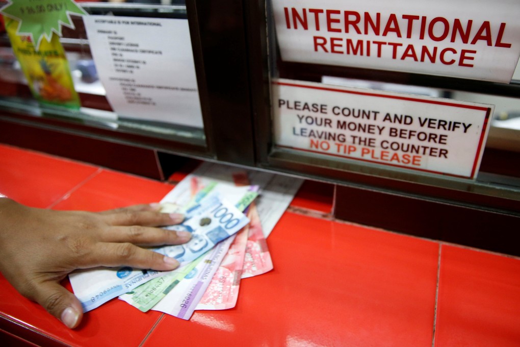Philippine peso bills are received at a money remittance center in Manila. Seventy per cent of the adult population in the Philippines is either unbanked or under-banked. Photo: Reuters