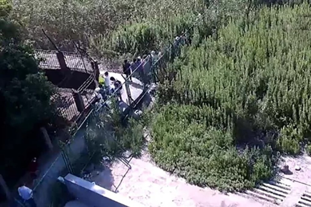 Volunteers bypass fences to carry out monitoring activities near a military facility in Shanghai. Photo: Central Political and Legal Affairs Commission