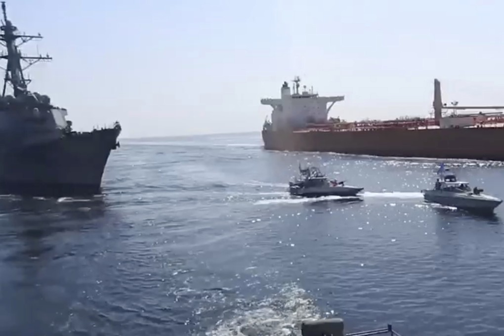 Revolutionary Guard speed boats are seen in front of a US warship (left) amid the seizure of a Vietnamese-flagged oil tanker in the Gulf of Oman. Photo: Revolutionary Guard via AP
