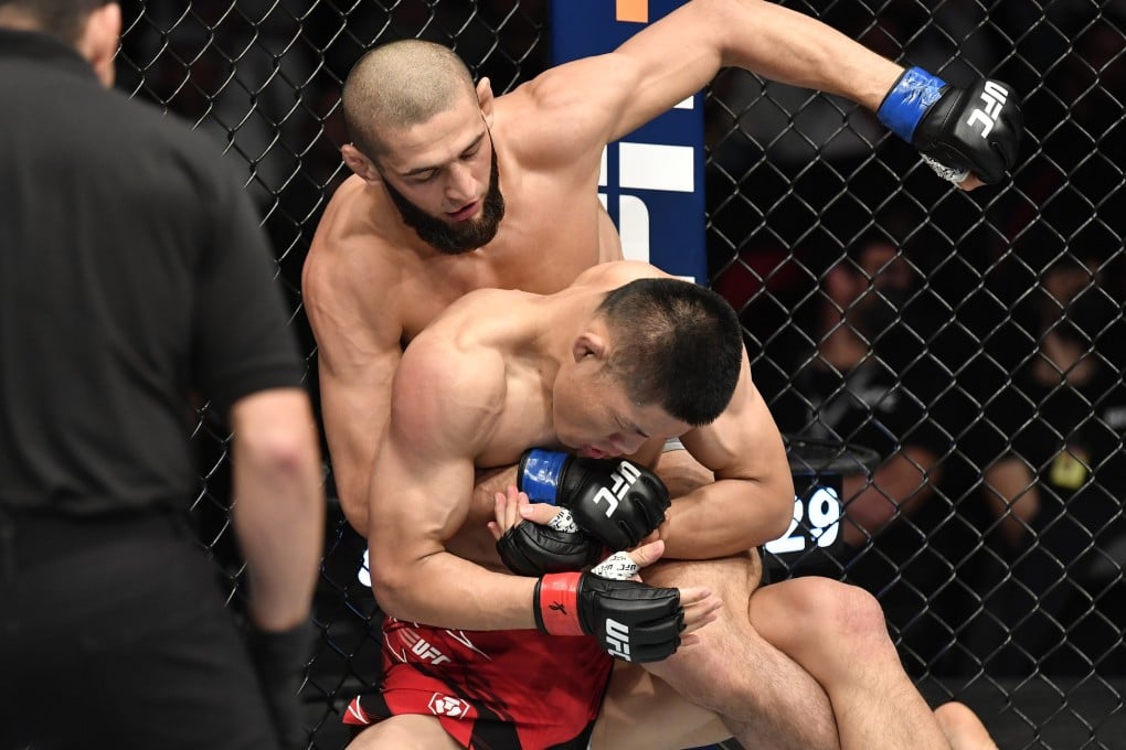 Khamzat Chimaev punches Li Jingliang in their welterweight fight at UFC 267. Photo: Chris Unger/Zuffa LLC