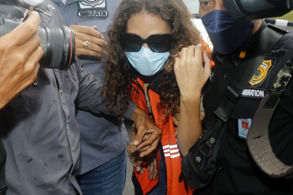 Heather Mack is escorted by immigration officers in Bali, Indonesia on Friday. Photo: AP