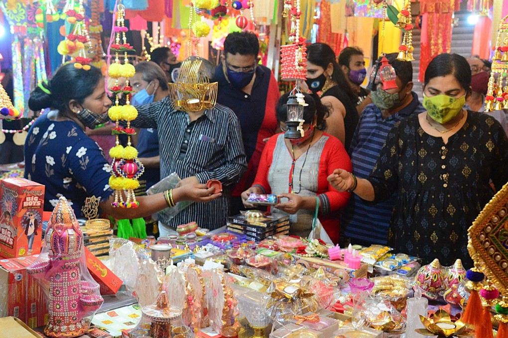 People in Mumbai shop for paper lanterns and other decorative items ahead of Diwali. Photo: AFP