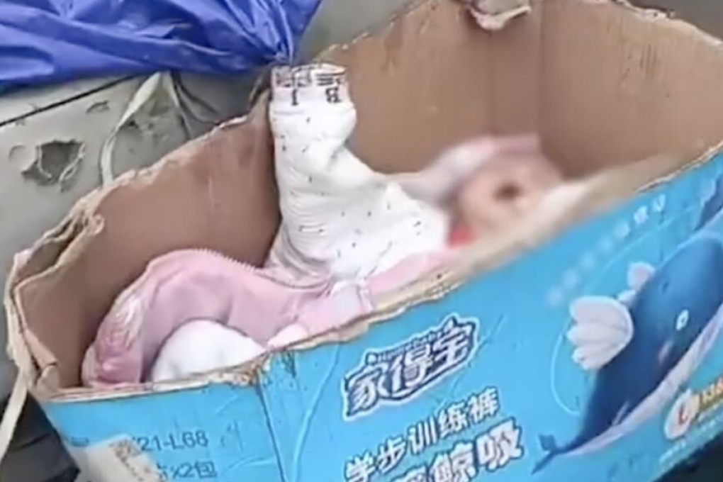 A viral video showed a baby being held in a rotting paper box next to buckets used for pigswill. Photo: Weibo