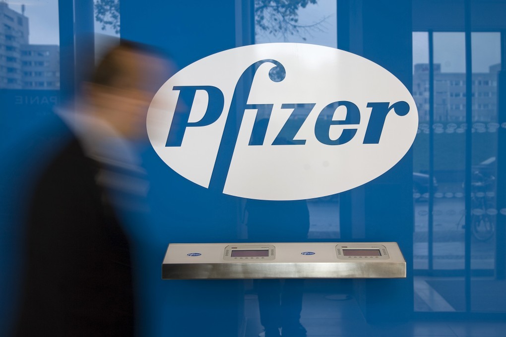 A man walks past the logo of Pfizer at its offices in Berlin. Photo: dpa