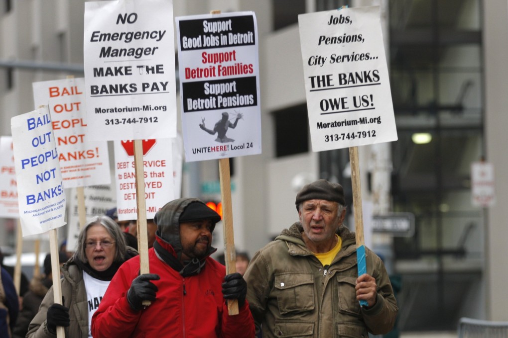 Protesters rally outside the Detroit Federal Court House on December 3, 2013, during a bankruptcy hearing declaring Detroit is eligible for the biggest municipal bankruptcy in US history. Photo: Reuters.