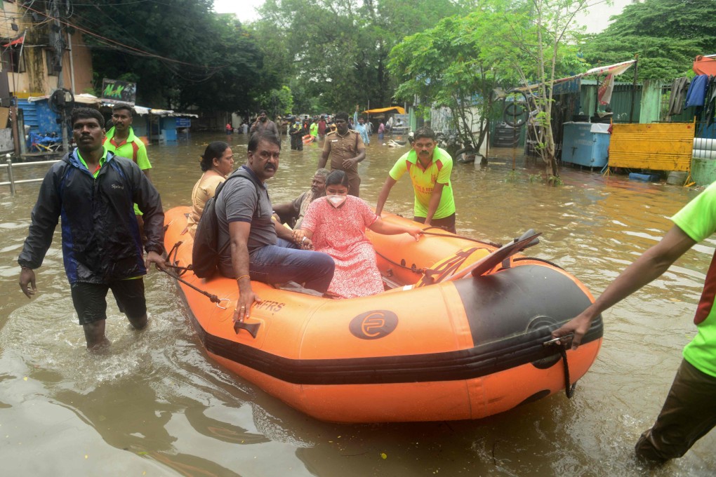 Firefighters rescue people on a boat from a flooded residential area after heavy rain in Chennai, India on November 7. Photo: AFP