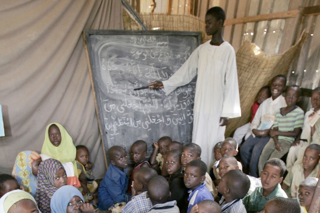 A teacher in Niger works with students in a house serving as a school for Koranic studies in 2005. The nation, one of the world’s poorest, has a shortage of school buildings. File photo: AFP