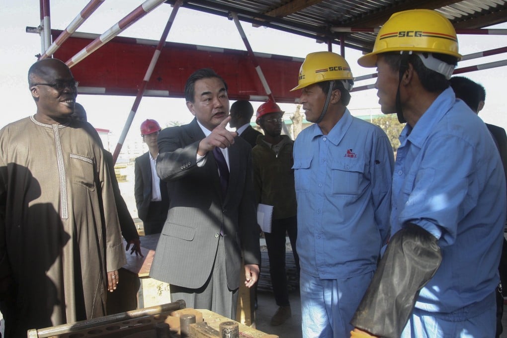 Chinese Foreign Minister Wang Yi (second from the left) visits a Chinese-funded project in Dakar, Senegal. File photo: EPA
