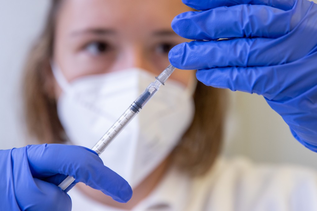 A health worker draws up a syringe with the Pfizer Covid-19 vaccine against Covid-19 in a temporary mobile vaccination centre in Bavaria. Photo: DPA