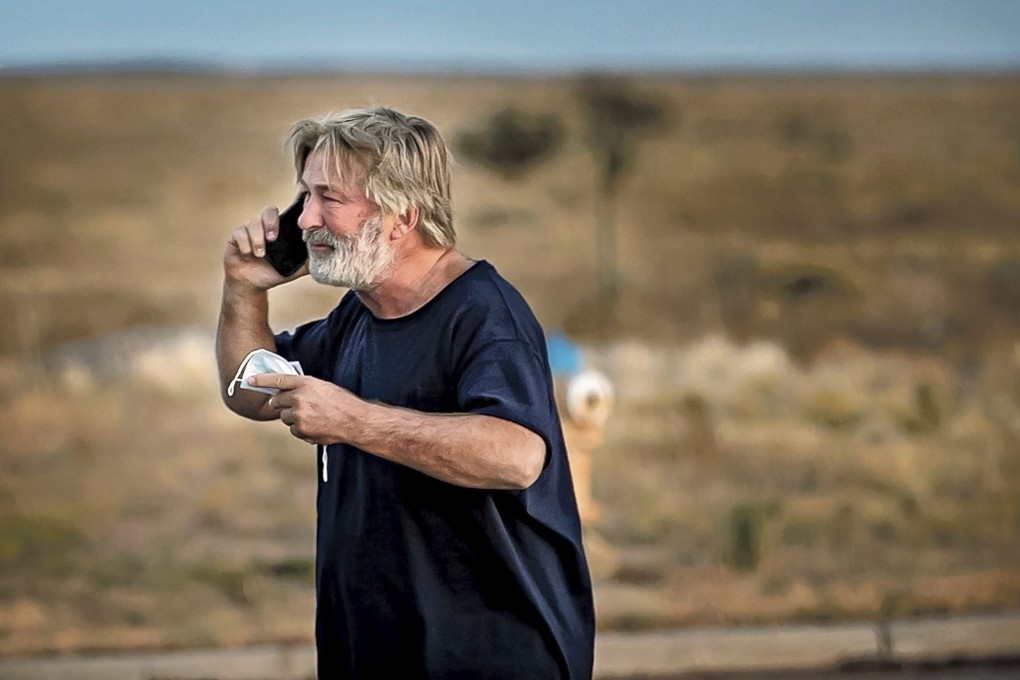 Alec Baldwin speaks on the phone in the car park outside the Santa Fe County Sheriff's Office on October 21 after he was questioned about a shooting on the set of the film Rust. Photo: Santa Fe New Mexican via AP
