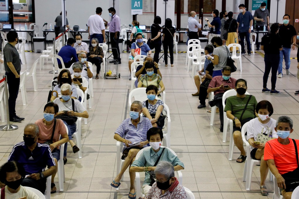 Residents wait at a Covid-19 vaccination centre in Singapore. File photo: Reuters