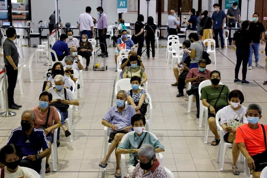 Residents wait at a Covid-19 vaccination centre in Singapore. File photo: Reuters