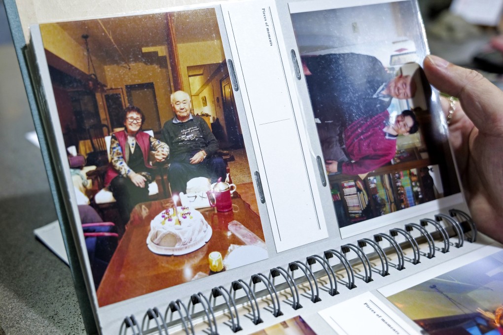 Adams Chi looks at photos of his parents. Chi and others who lost loved ones to outbreaks in Taiwan are angry that their government did not prepare enough. Photo: AP