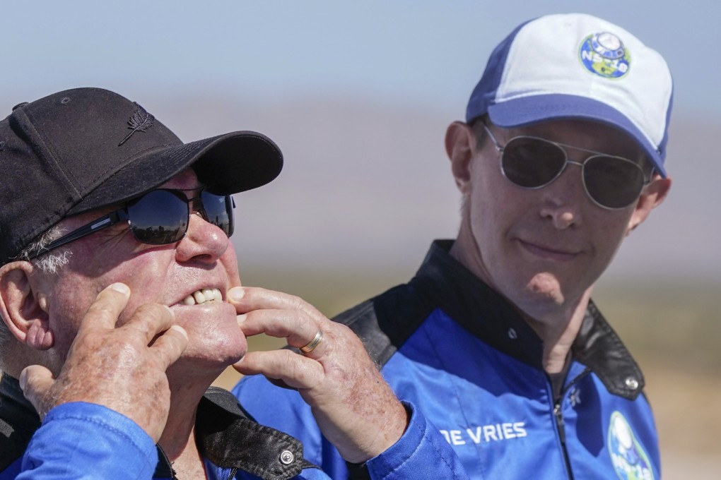 Glen de Vries (right) looks on as William Shatner talks about what rocket lift off did to his face during a press event at the spaceport near Van Horn, Texas, in October. Photo: AP