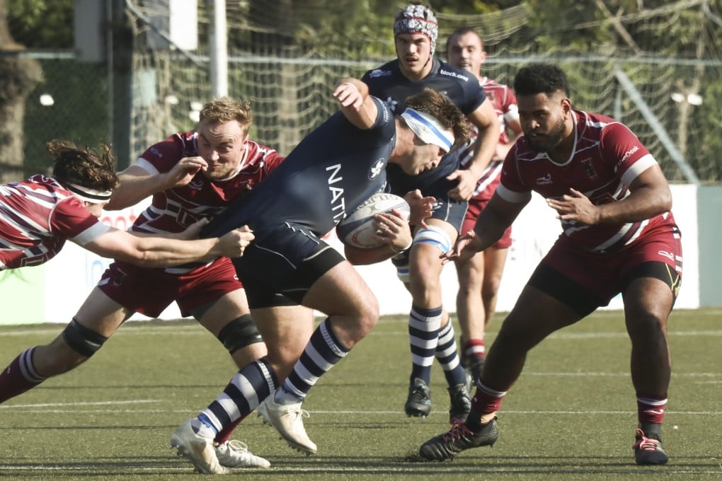 Hong Kong Football Club captain Ben Axten-Burrett fights his way through Kowloon’s defence at King’s Park. Photo: Jonathan Wong