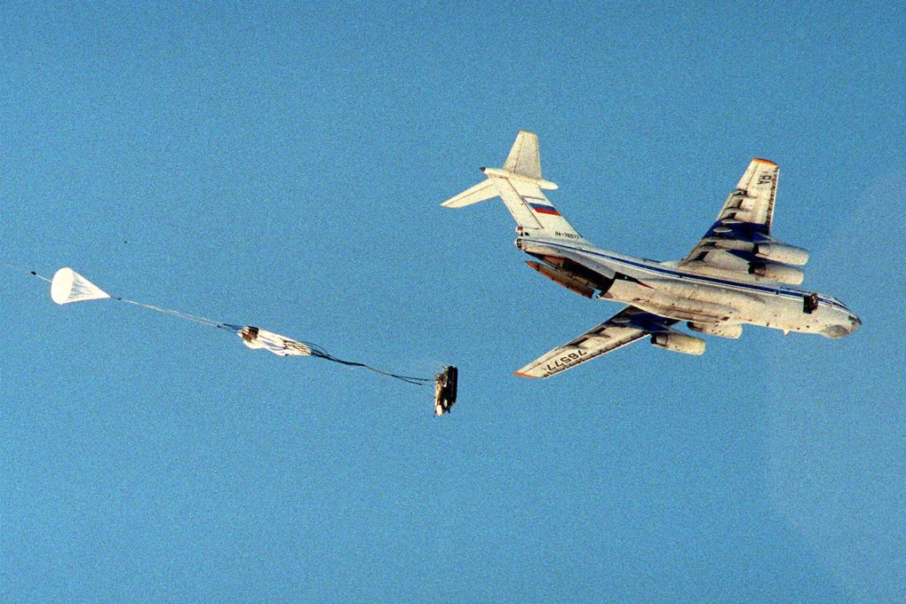 An armoured vehicle with a crew member inside is parachuted from Il-76 plane during military exercises near Kostroma, 400km north of Moscow in March 1999. Il-76 aircraft were also used during the drills in Belarus on Friday. Photo: AP