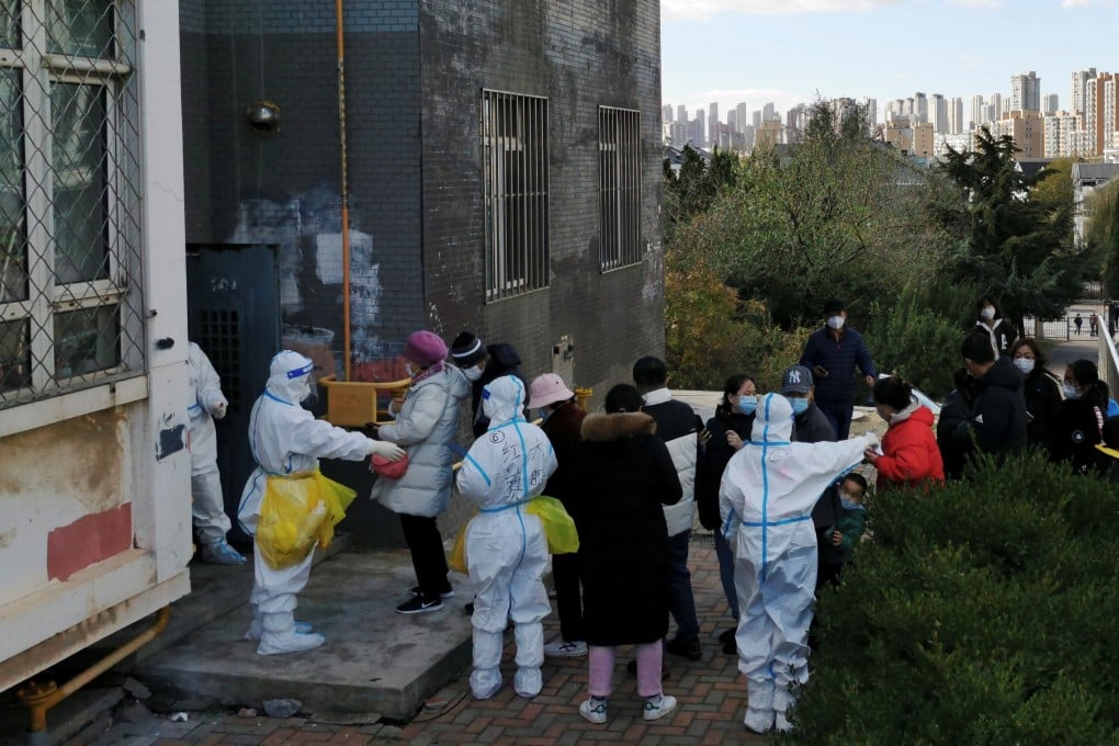 People line up for nucleic acid testing at a residential compound in Dalian. Photo: Reuters