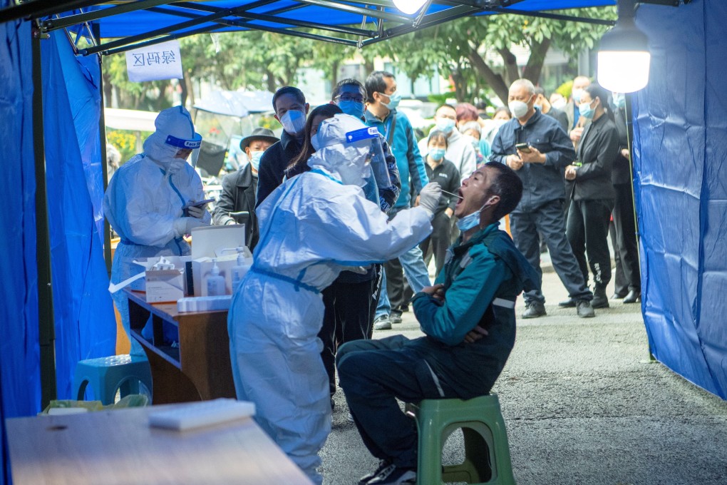 People line up at a makeshift testing site near a locked down residential compound following local cases of the coronavirus in Chengdu. Photo: cnsphoto via Reuters