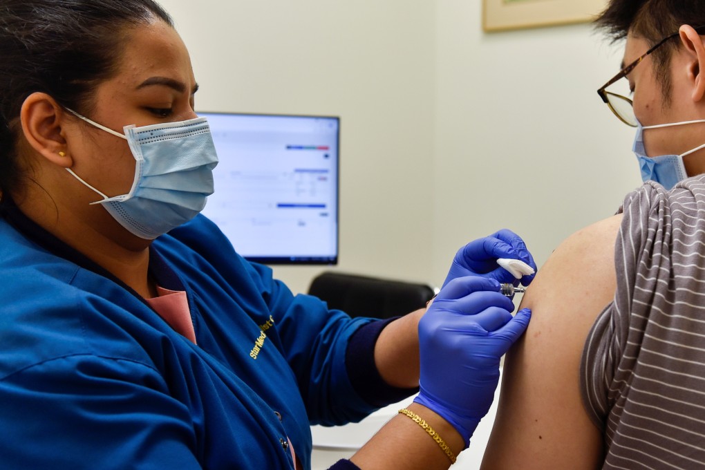A nurse administers a Covid-19 vaccine to a patient in Singapore earlier this year. Photo: Reuters