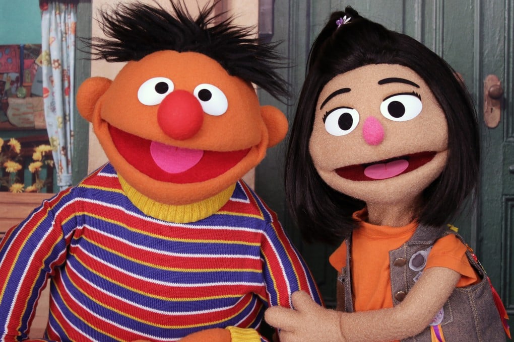 Ernie, a muppet from Sesame Street, appears with new character Ji-Young (right), on the set of the TV show in New York. Photo: AP