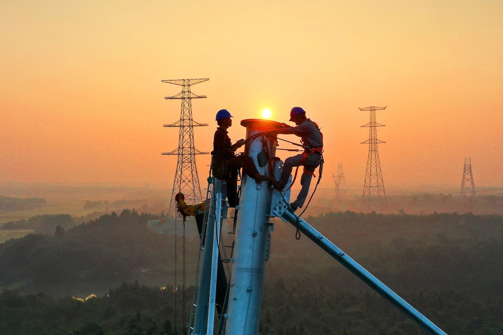 Employees working on high voltage transmission tower in Yichun, in China's central Jiangxi province in September 2021. Photo: AFP