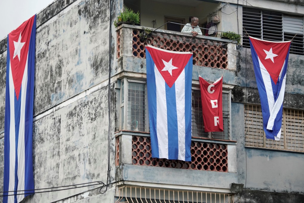 Cuban flags cover the windows of the house of a dissident leader in Havana on Monday. Photo: Reuters
