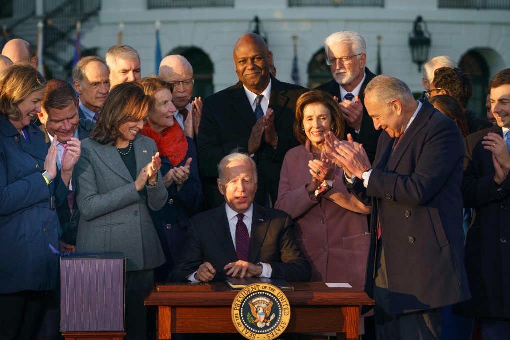 US President Joe Biden, centre, receives applause after signing the Infrastructure Investment and Jobs Act on the South Lawn of the White House in Washington on Monday. Photo: AFP