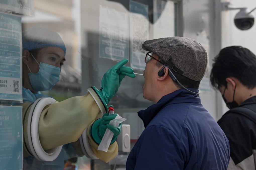 A health worker takes a swab sample at a testing site in Beijing. Authorities are taking no chances in the lead-up to the Winter Games in February. Photo: AFP