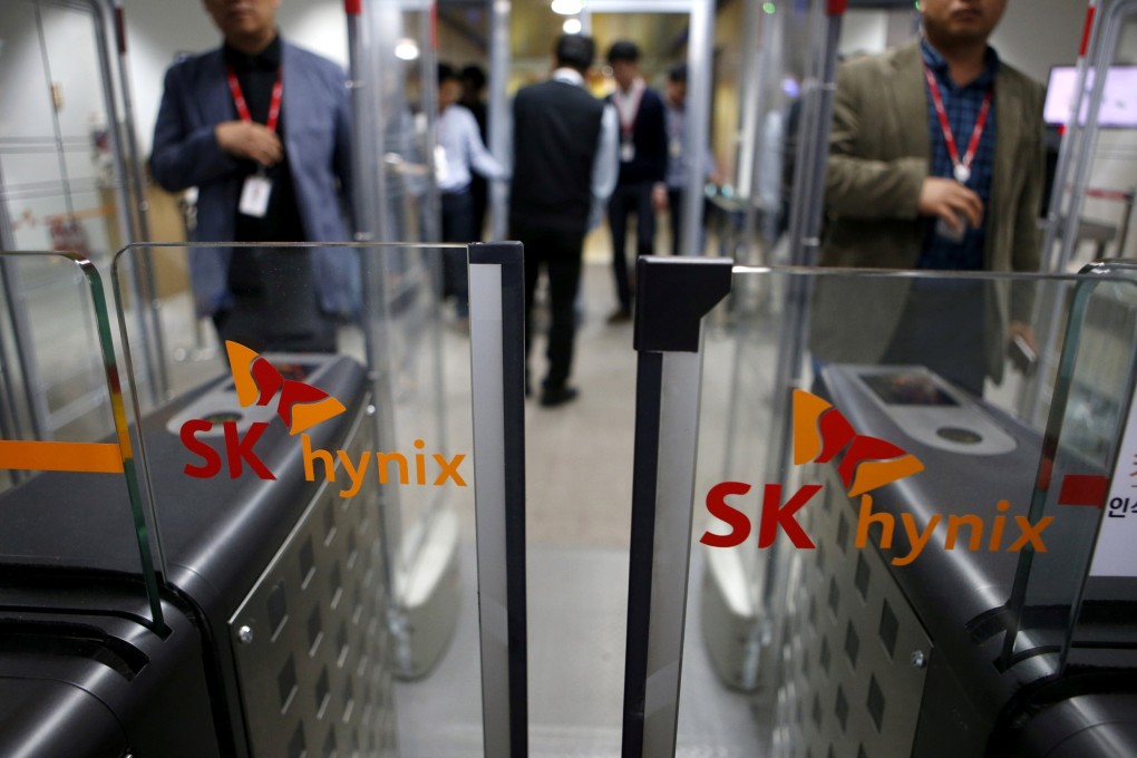 Employees walk past identification systems bearing the logos of SK Hynix at its headquarters in Seongnam, South Korea. Photo: Reuters