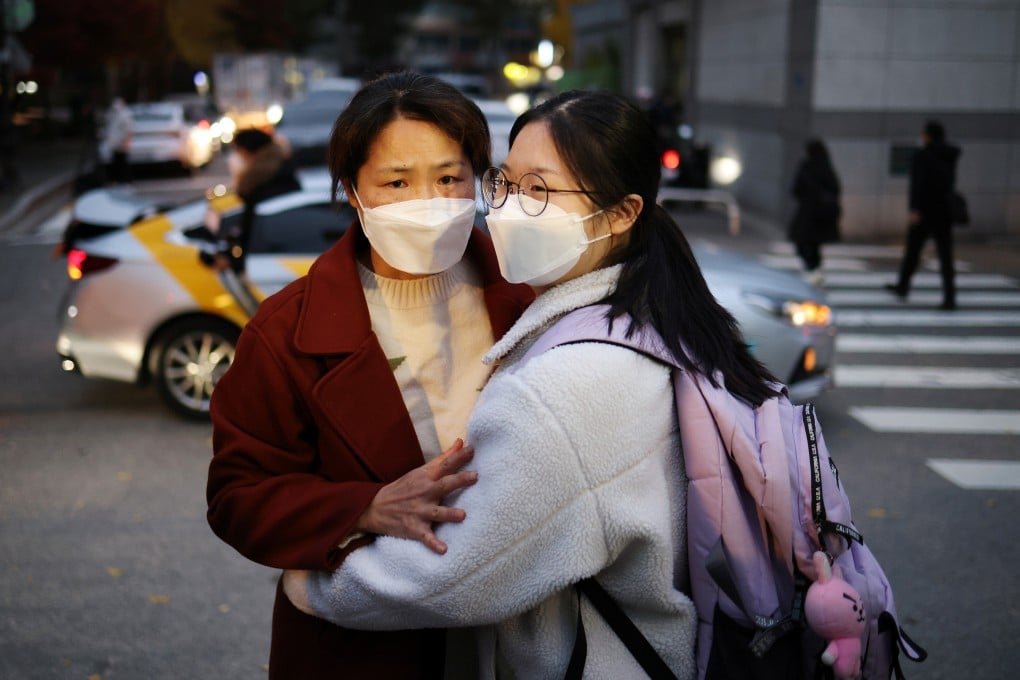 A mother hugs her daughter ahead of her Suneung exams in Seoul on Thursday. Photo: Reuters