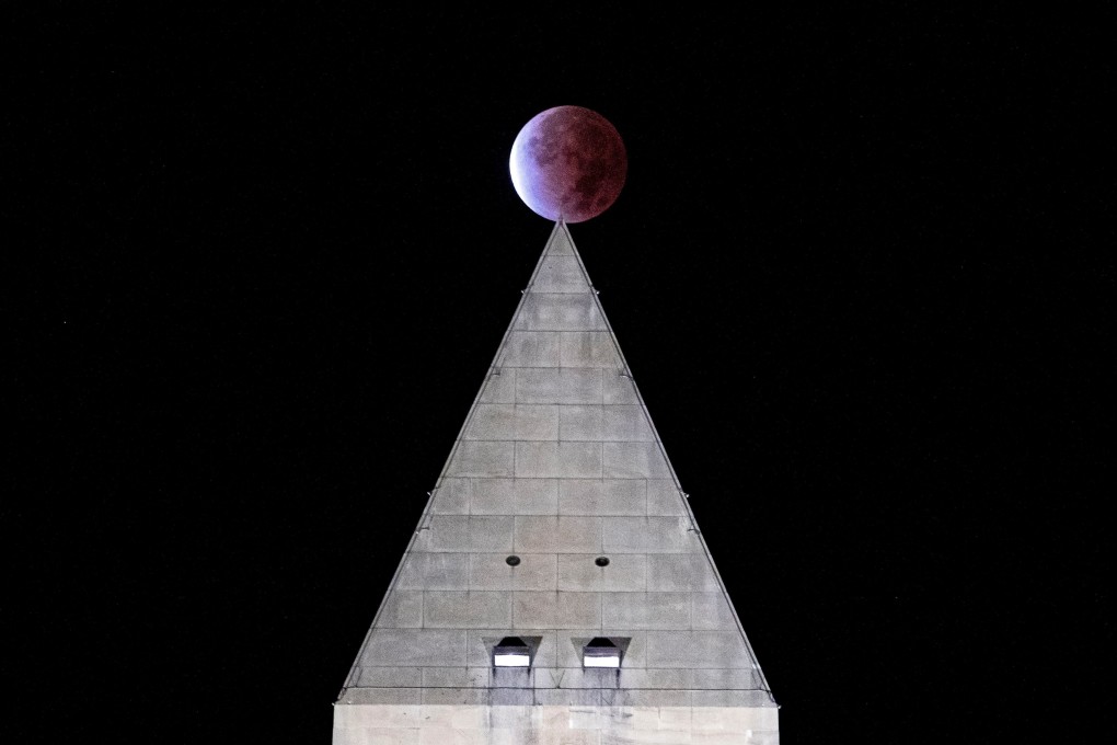 The moon, as seen from Washington DC, with the Washington Monument in the foreground. Photo: Reuters