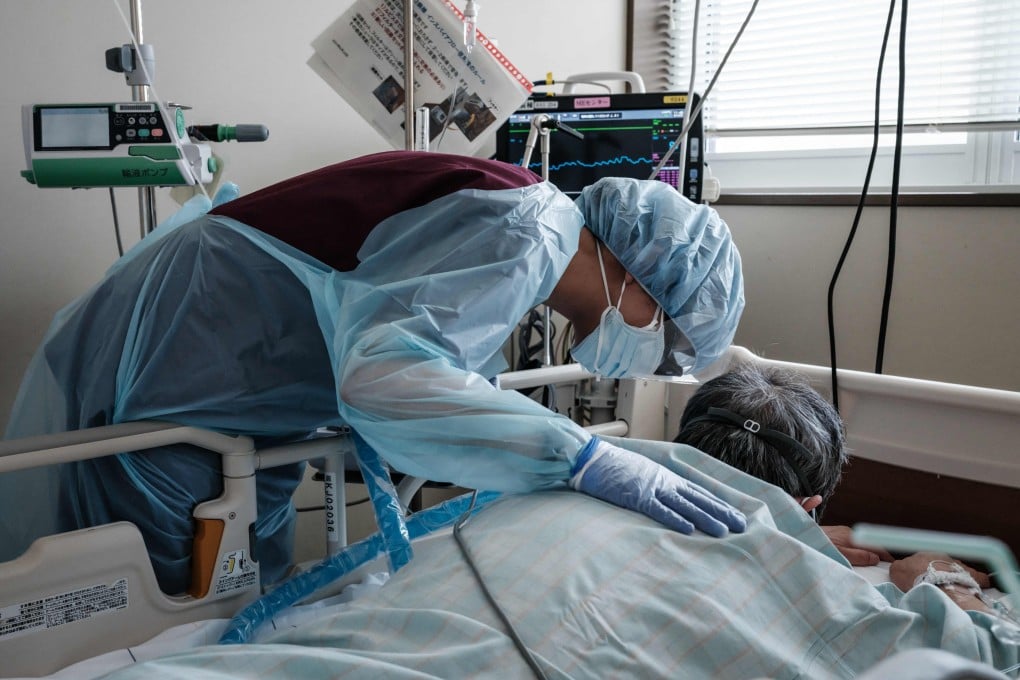 A health worker speaks to a Covid-19 patient at a hospital in Hokkaido. File photo: AFP