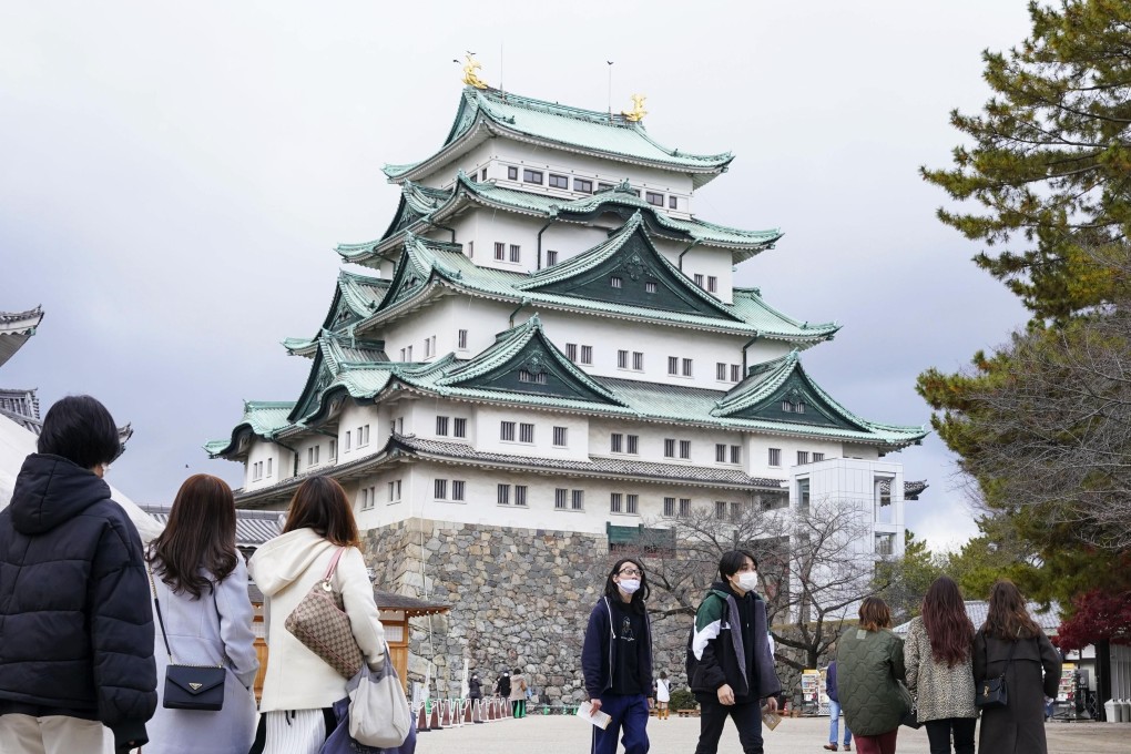 People wearing face masks visit Nagoya Castle in central Japan. Photo: Kyodo