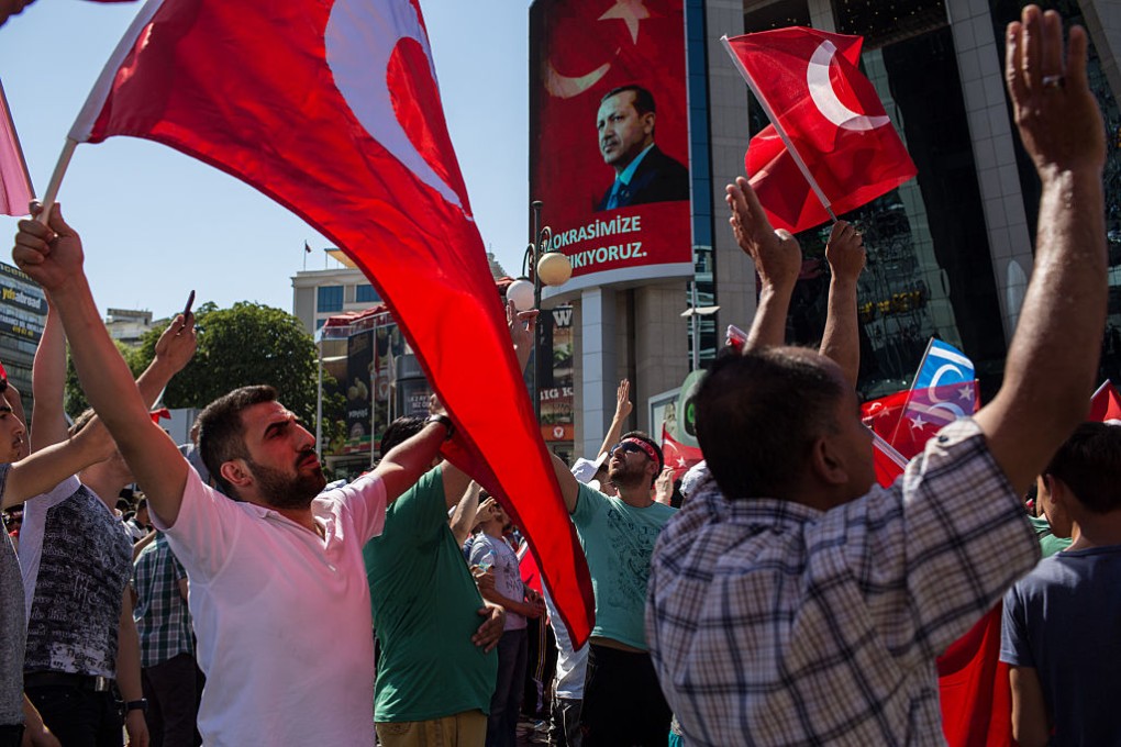 People wave Turkish flags during a march around Kizilay Square in reaction to the attempted military coup in Ankara, Turkey. Photo: Chris McGrath /Getty Images