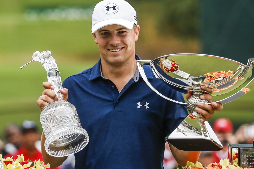 Jordan Spieth of the US lifts the TOUR Championship trophy and the FedEx Cup. Photo:  EPA