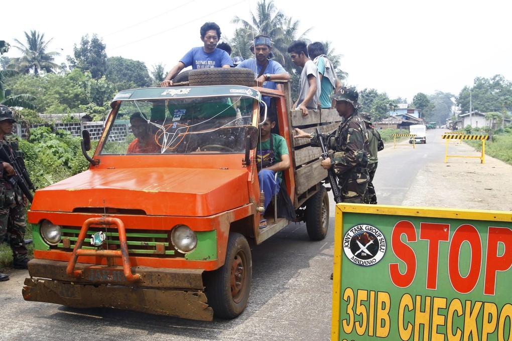 epa04944300 Filipino soldiers conduct inspections on a vehicle at a military checkpoint on the outskirts of Jolo, Sulu island, southern Philippines, 23 September 2015. Two Canadian citizens and a Norwegian resort manager were abducted by unidentified gunmen on an island in the southern Philippines, police and military said. A Filipino woman, the girlfriend of one of the foreigners was also taken from the resort on Samal Island, 980km south of Manila, regional military spokesman Captain Alberto Caber said. Caber identified the foreign hostages as John Ridsdel, 68, a consultant with Canadian mining company TVI Pacific Inc; Canadian Robert Hall, 60; and Norwegian Kjartan Sekkingstad, 56. Samal Island, known for its powdery sand beaches and pristine diving spots, is one of the tourism destinations in the province of Davao Del Norte. In 2001, al-Qaeda-linked Abu Sayyaf extremists tried but failed to abduct tourists from Samal Islands's Pearl Farm Resort. EPA/BEN HAJAN