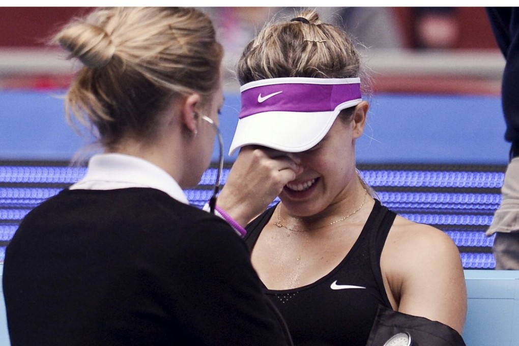 Eugenie Bouchard of Canada is treated during her match against Andrea Petkovic of Germany at the China Open in Beijing.