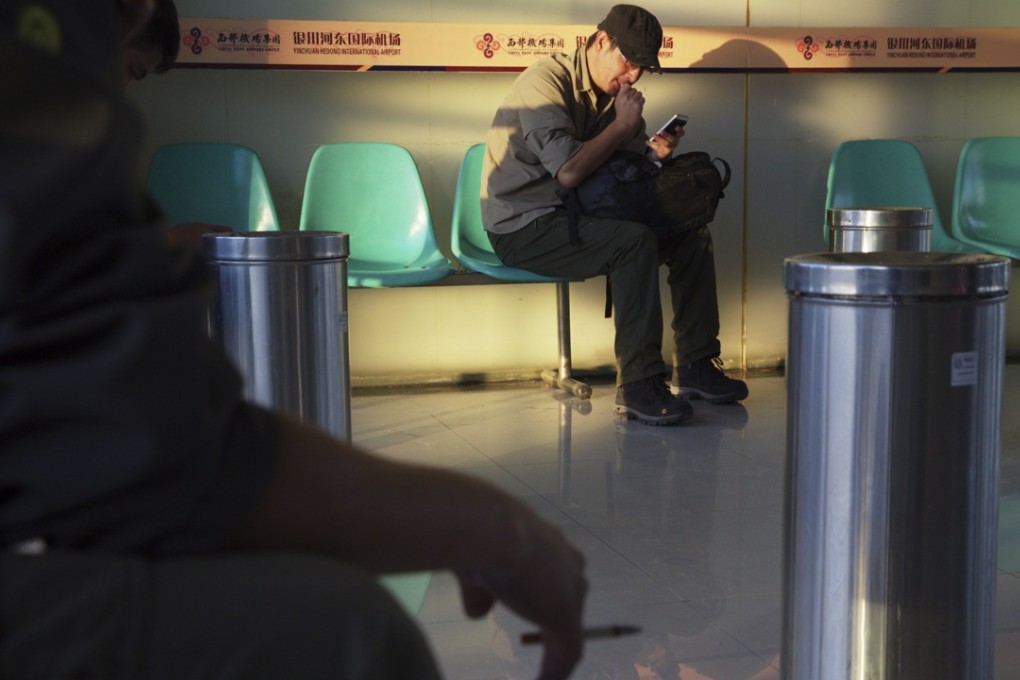 Men smoke in northwestern China's Yinchuan airport in October. Photo: AP