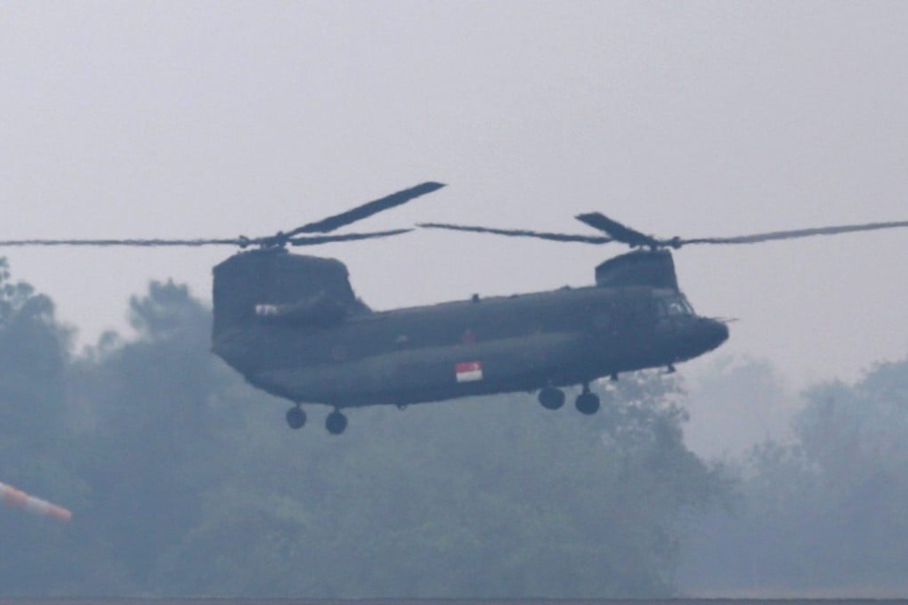 A Singaporean crew aboard a Chinook helicopter arrives at the Sultan Mahmud Badaruddin II Airport in Indonesia to combat the forest fires. Photo: EPA