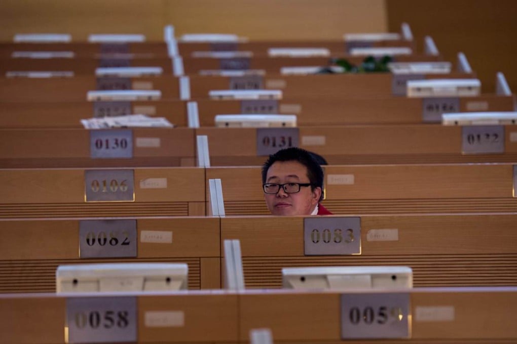 A man works on the trading floor at the Shanghai Stock Exchange in the Lujiazui Financial district of the city. Photo: AFP